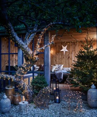 An understated outdoor Christmas lighting scheme with fairy lights on tree