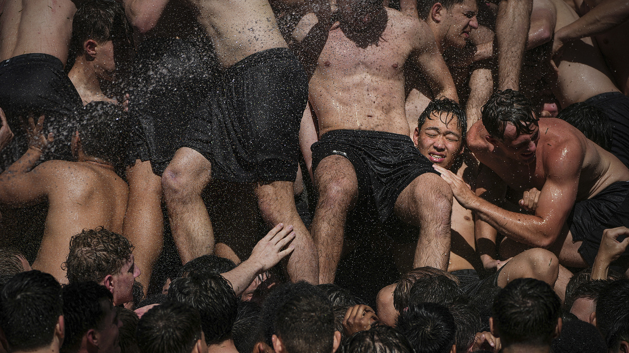 First-year midshipmen climb the Herndon Monument to cap off their "plebe year" at the U.S. Naval Academy in Annapolis, Maryland