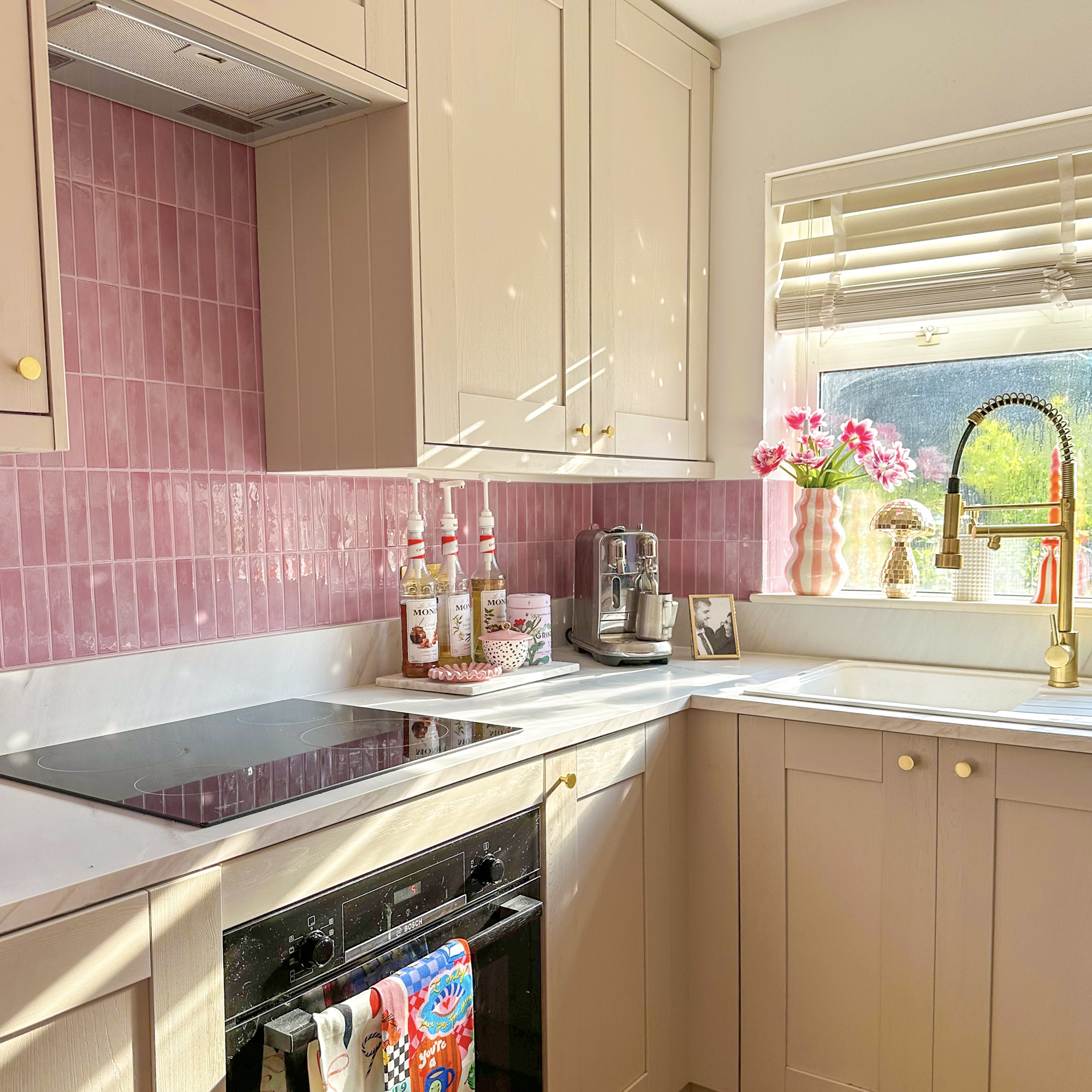 Kitchen with pink peel and stick splashback tiles