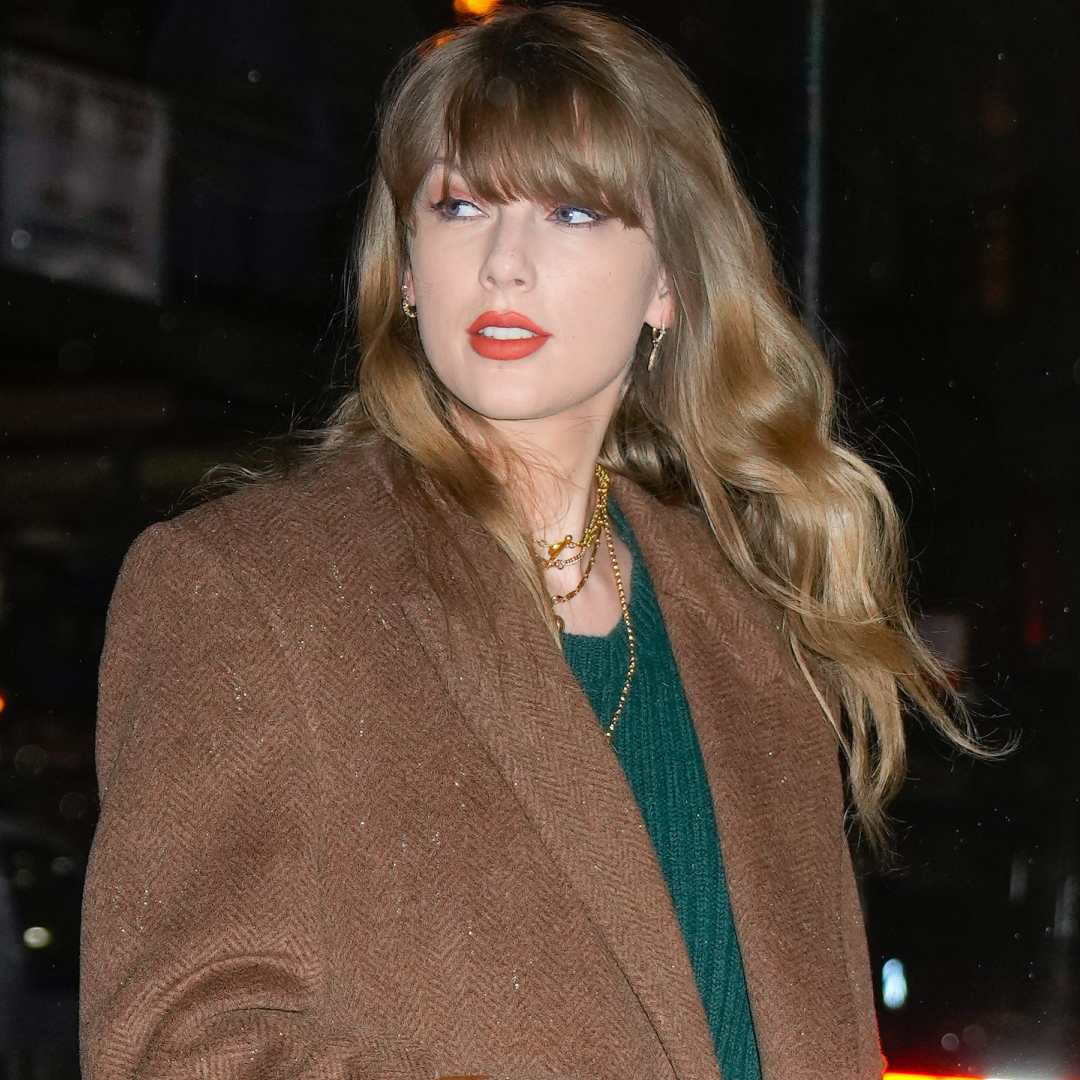 Taylor Swift posed with a fan in an anti-Showgirl plaid mini skirt