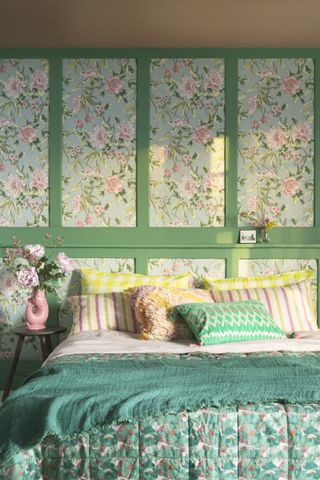 green bedroom with traditional wallpaper in vintage floral inspired design, and mix and match pastel hued bedding.