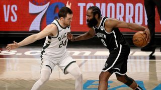 James Harden #13 of the Brooklyn Nets tries to get past Pat Connaughton #24 of the Milwaukee Bucks during game seven of the Eastern Conference second round at Barclays Center on June 19, 2021 in the Brooklyn borough of New York City.