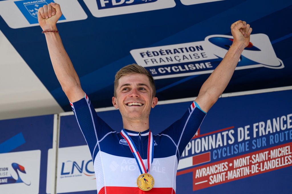 Decathlon-Ag2r-La Mondiale team&#039;s cyclist Paul Lapeira celebrates on the podium after winning first place in the Elite road men French championships race, next to Lidl trek&#039;s 2nd placed Julien Bernard (L) and Total Energies&#039; 3rd placed Thomas Gachignard, in Saint-Martin-de-Landelles, western France, on June 23, 2024. France will have four riders - the maximum allowed - at the start of the road cycling road race of the Paris 2024 Olympic Games. (Photo by LOIC VENANCE / AFP)