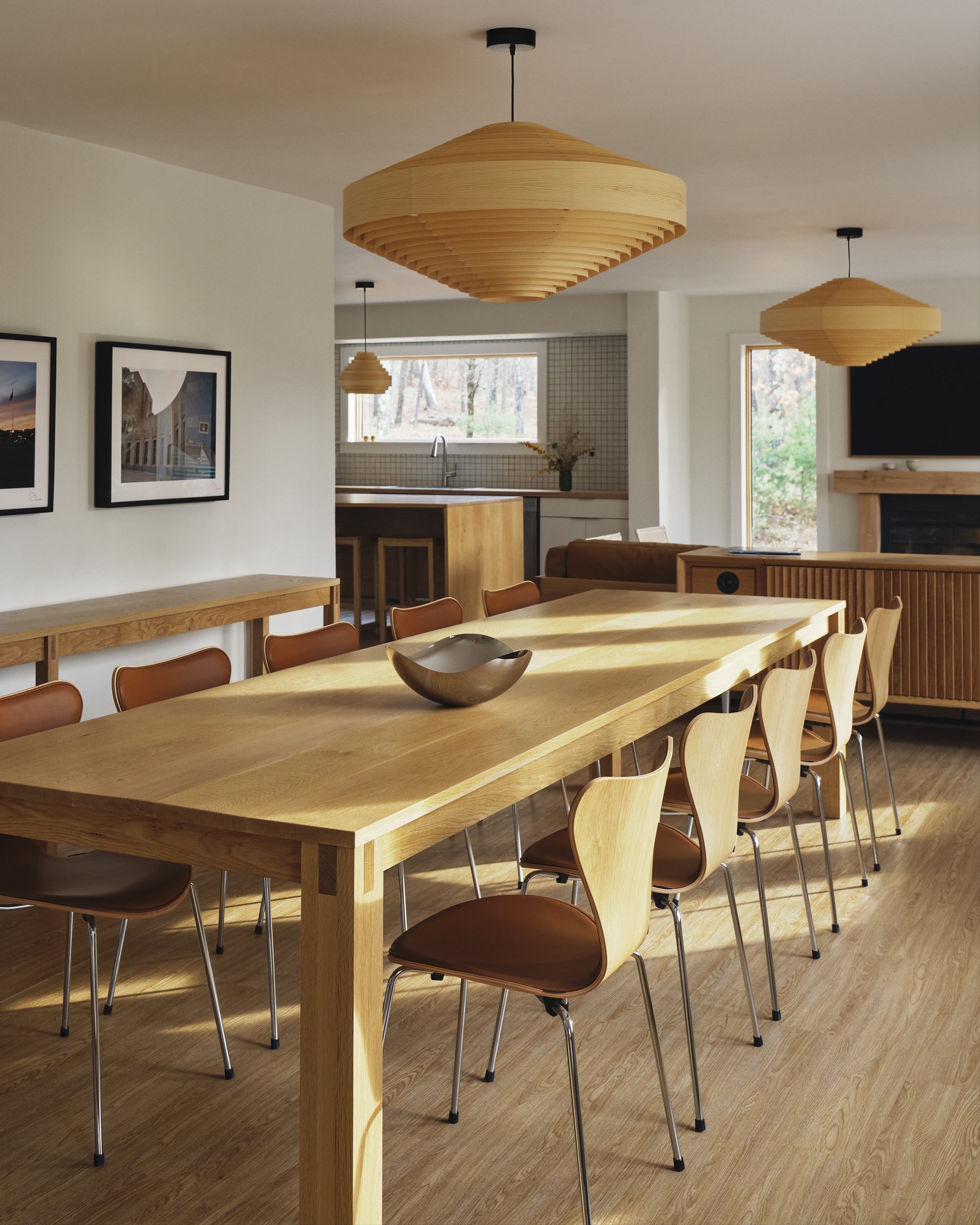 A long wooden dining table with wooden chairs.