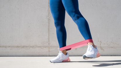 A woman trying one of the best advanced resistance band leg workouts