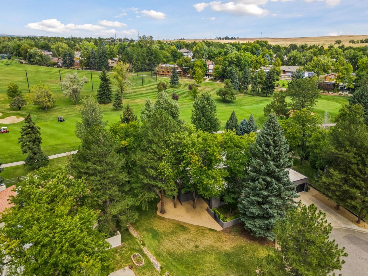 A modern home for sale in Boulder, Colorado by a golf course.