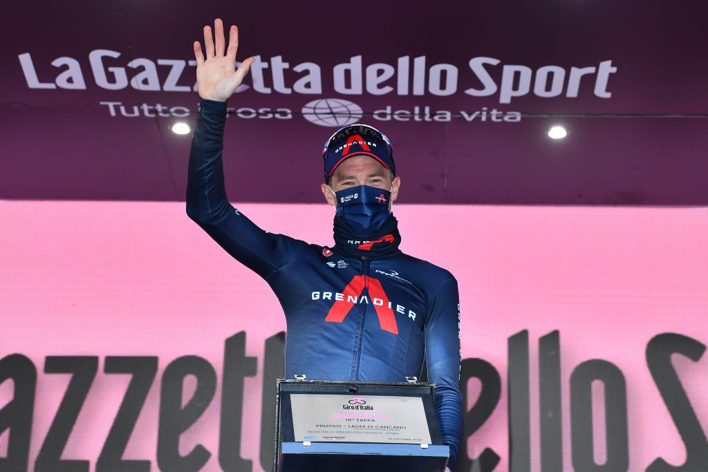 LAGHI DI CANCANO ITALY OCTOBER 22 Podium Rohan Dennis of Australia and Team INEOS Grenadiers Celebration Cima Coppi Trophy Mask Covid safety measures during the 103rd Giro dItalia 2020 Stage 18 a 207km stage from Pinzolo to Laghi di Cancano Parco Nazionale dello Stelvio 1945m girodiitalia Giro on October 22 2020 in Laghi di Cancano Italy Photo by Stuart FranklinGetty Images