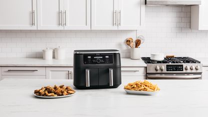 Three of the best dual zone air fryers on Ideal Home style background