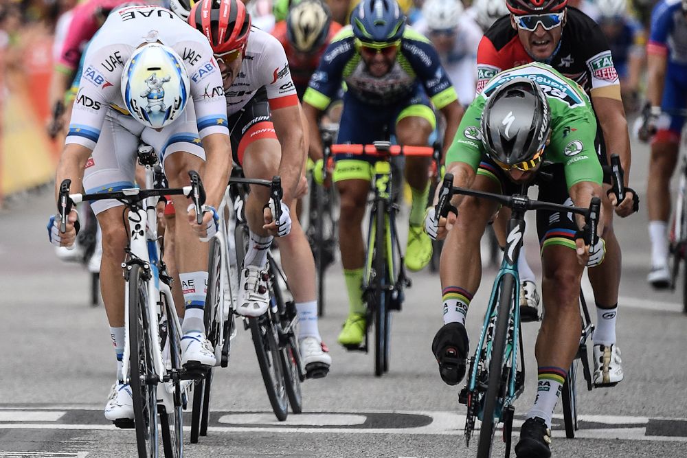 Alexander Kristoff and Peter Sagan throw their bikes for the line at the end of stage 13