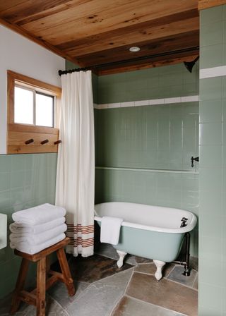 green coastal bathroom with pine ceiling