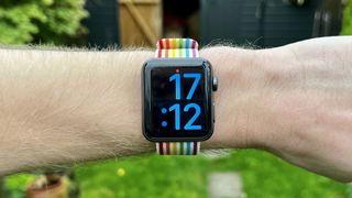 Image shows the Apple Watch 3 with a rainbow bracelet on a wrist.