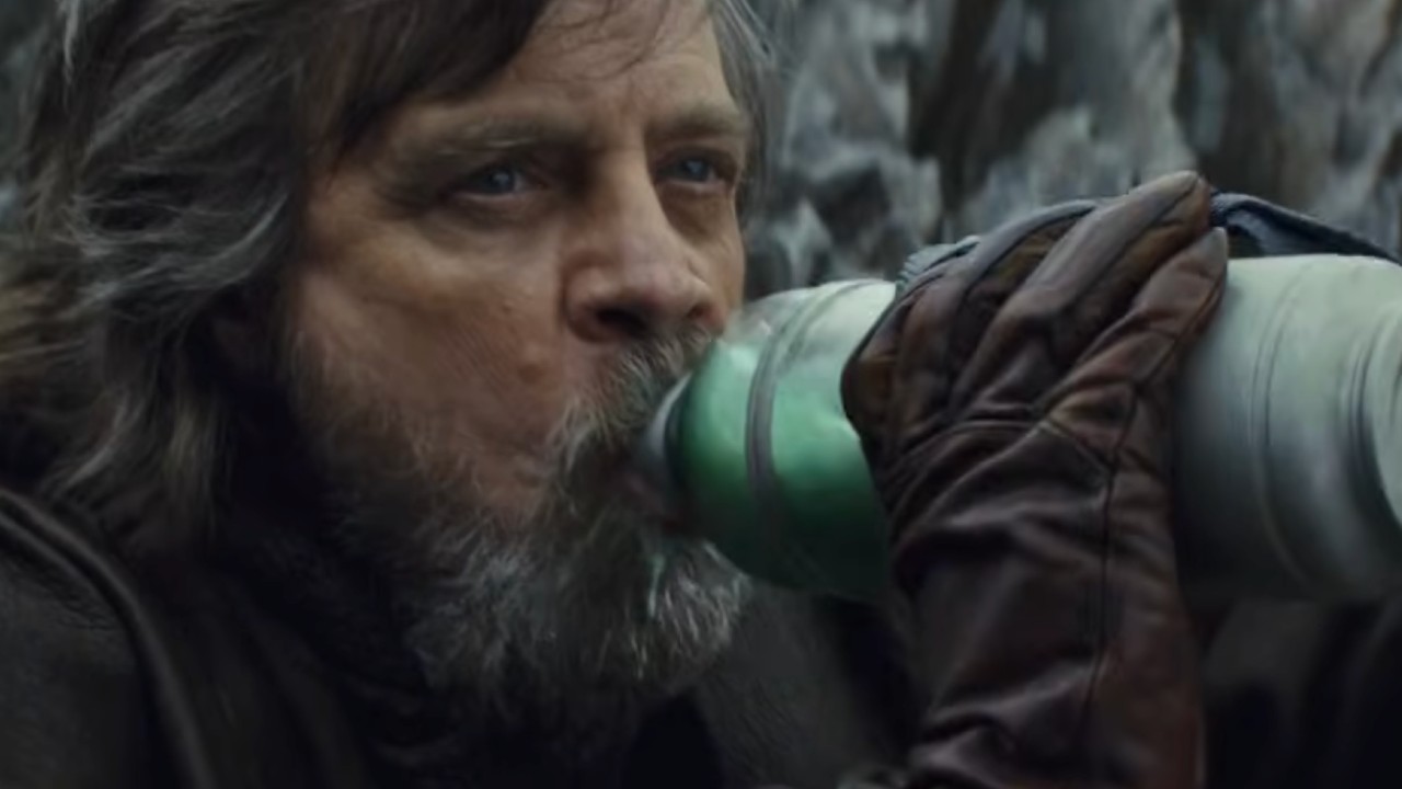 Luke chugging some green milk and looking at Rey