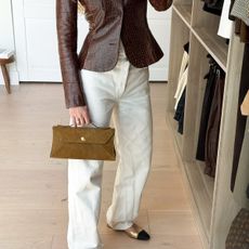 Influencer taking mirror selfie in closet