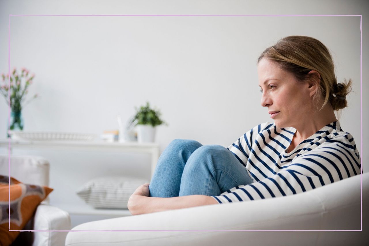 Lonely woman sat on her sofa