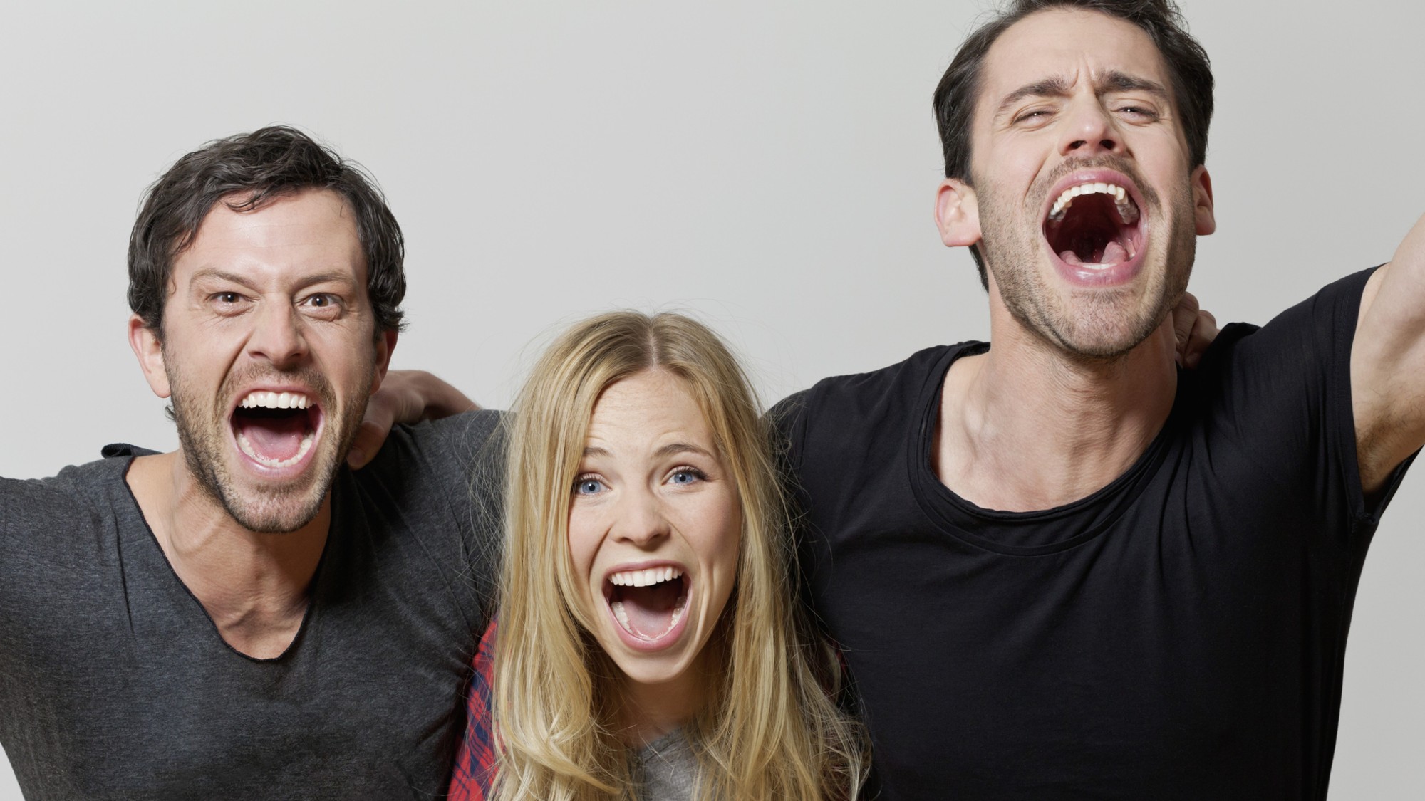 A woman and two men scream out their frustrations.