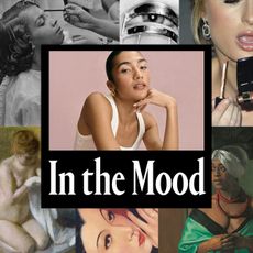 a woman with dark hair pulled back into a bun posing in front of a pink background