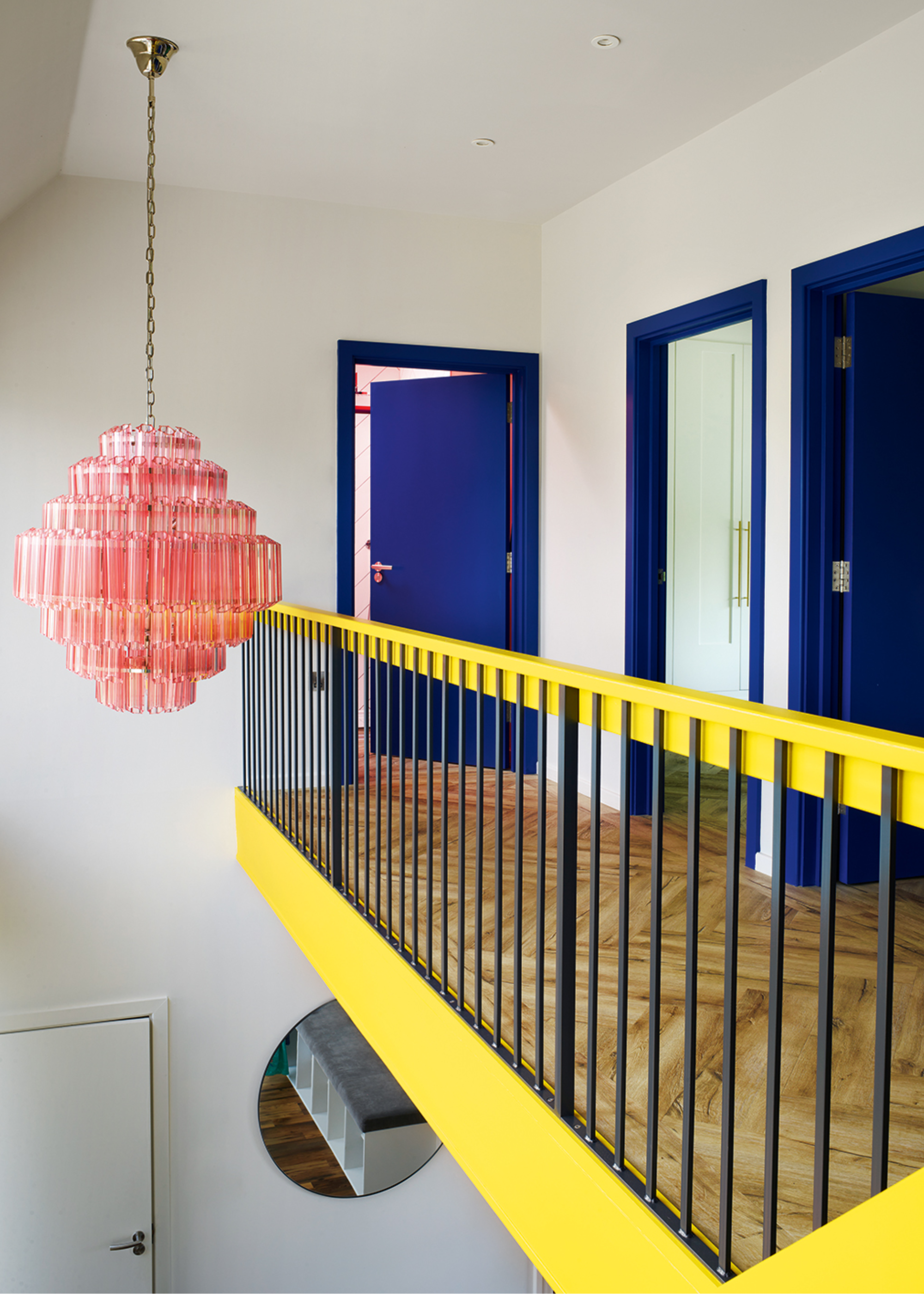 landing with yellow stair rail and blue doors