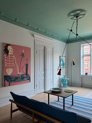 a living room with a teal ceiling