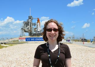 SPACE.com reporter Clara Moskowitz stands in front of the space shuttle Endeavour at Launch Pad 39A at Kennedy Space Center on the day before its final launch.