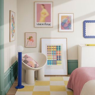 A bedroom with a checkered rug and art prints on the walls