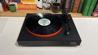 JBL Spinner BT turntable with INXS vinyl record from front slight elevated angle