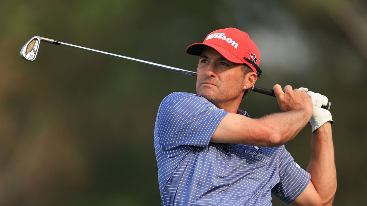 Kevin Kisner hits an iron shot and watches his ball flight