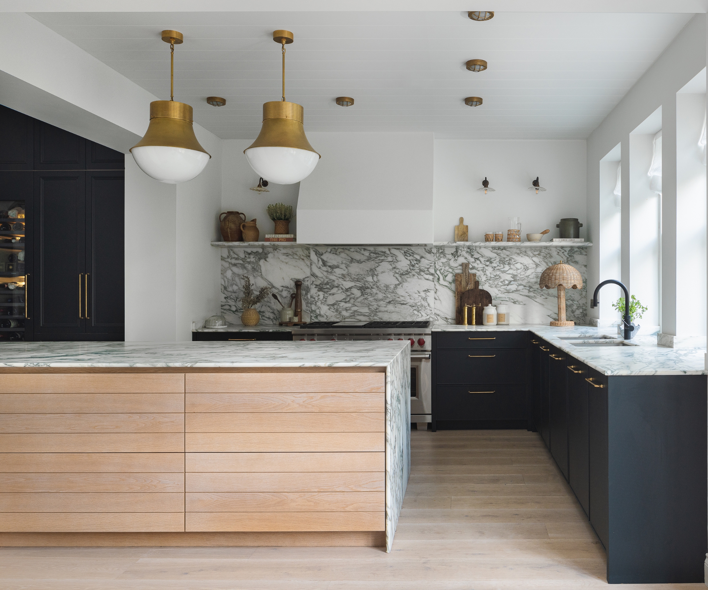 A blue and white kitchen with a wooden island