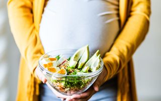 Woman pregnant with twins with a salad