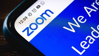 A close up of the corner of a smartphone with the Zoom logo displayed on screen