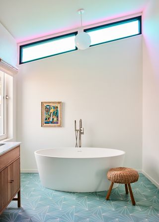 modern bathroom with freestanding round tub and small stool