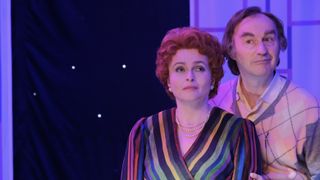Helena Bonham Carter in a striped top as Noele Gordon stands alongside Mark Gatiss in a pink and grey jumper as Larry Grayson in Nolly.