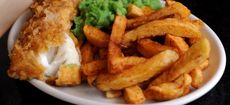 A plate of fish chips and mushy peas