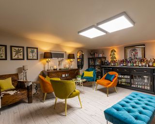 Basement or garage idea for man cave, with home bar and colorful, sociable seating.