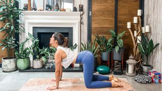 Woman doing Cat-Cow yoga pose.