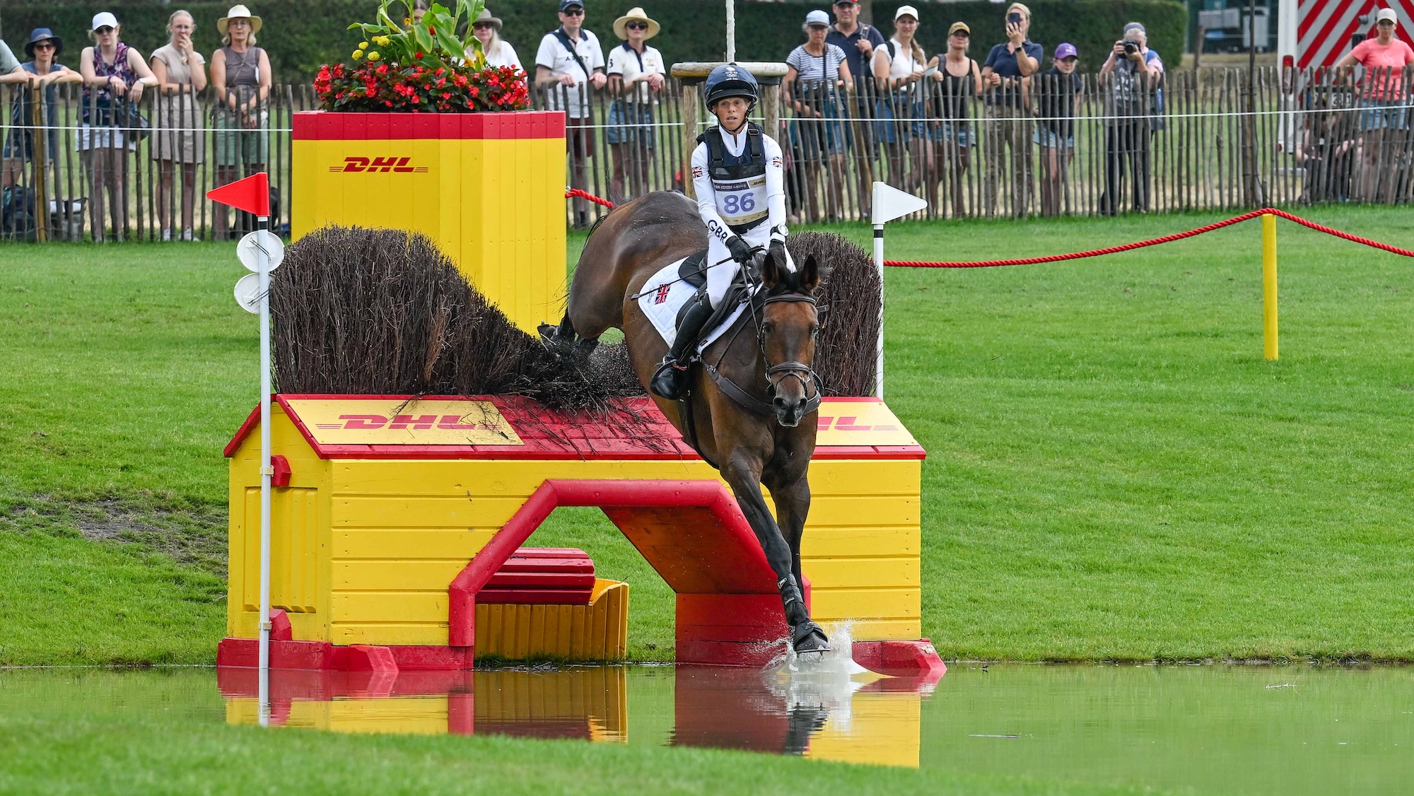 Ros Canter jumping yellow fence in water at Aachen eventing World Championship cross-country, finishing second in results