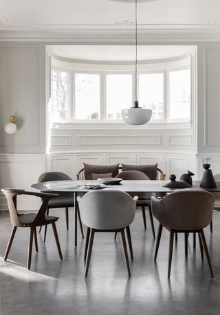 minimalist dining room with round wooden table