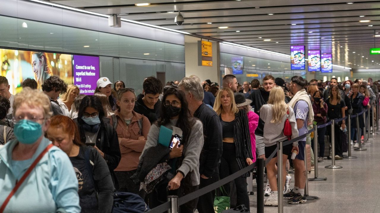 Travellers wait in a long queue 