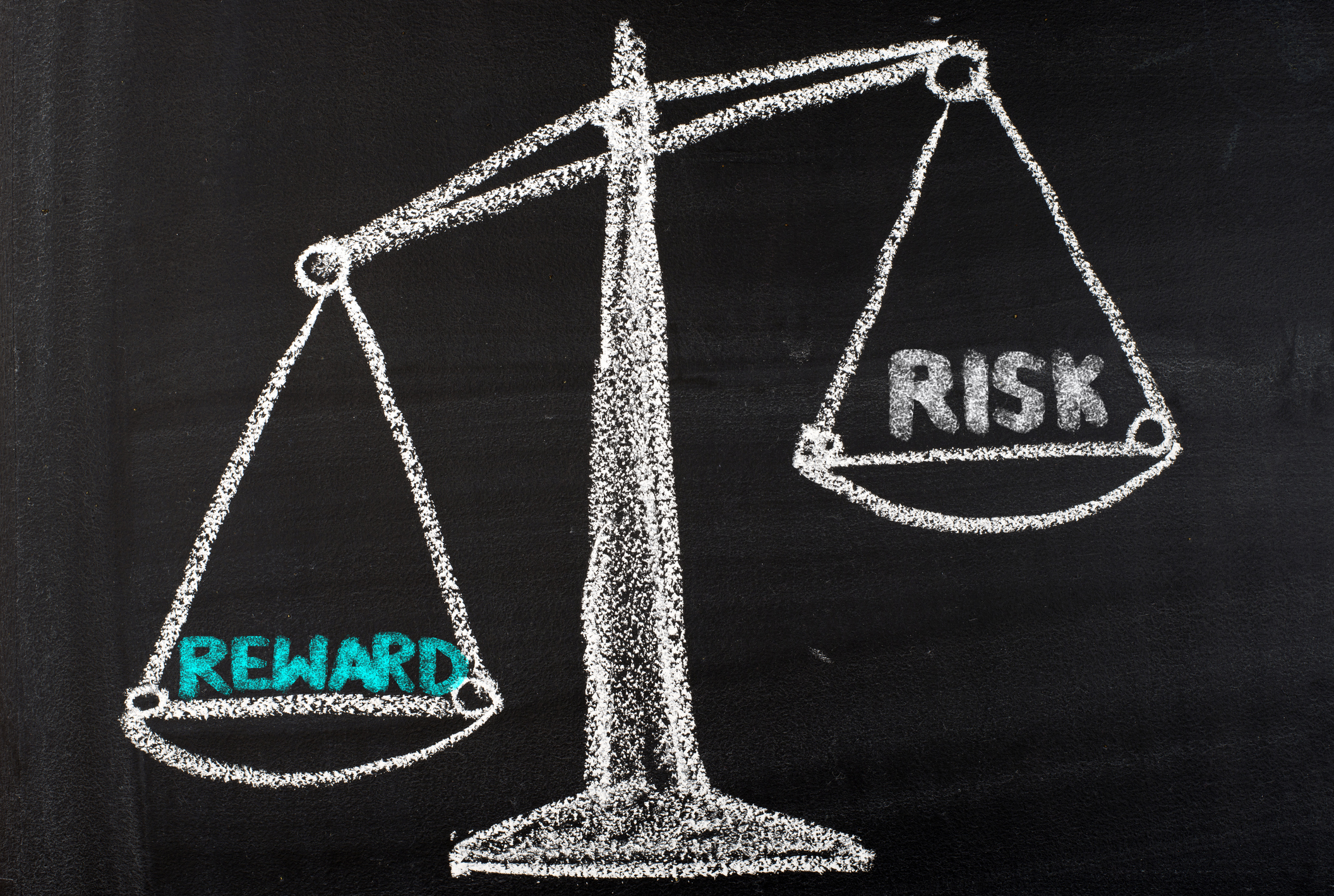 chalkboard drawing of a balancing scale with risk on one side and reward on the other