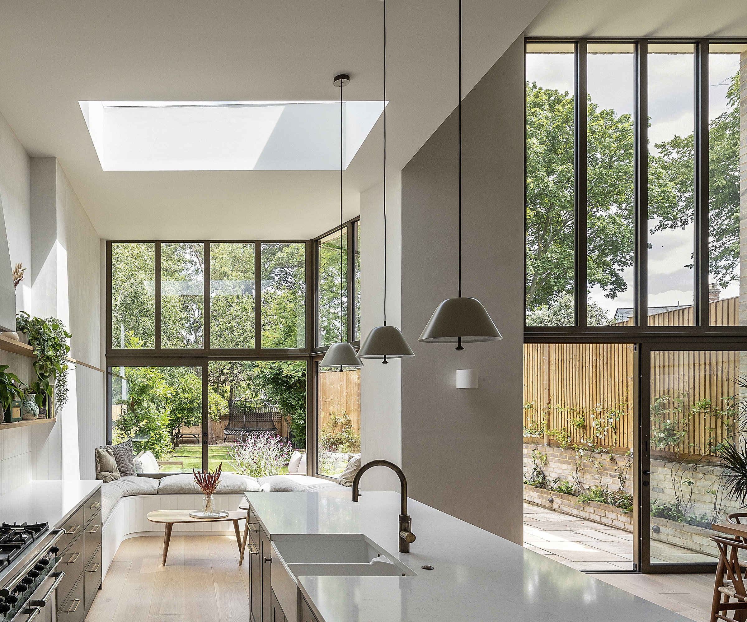 a downstairs kitchen extension with double-height ceilings and architectural glazing