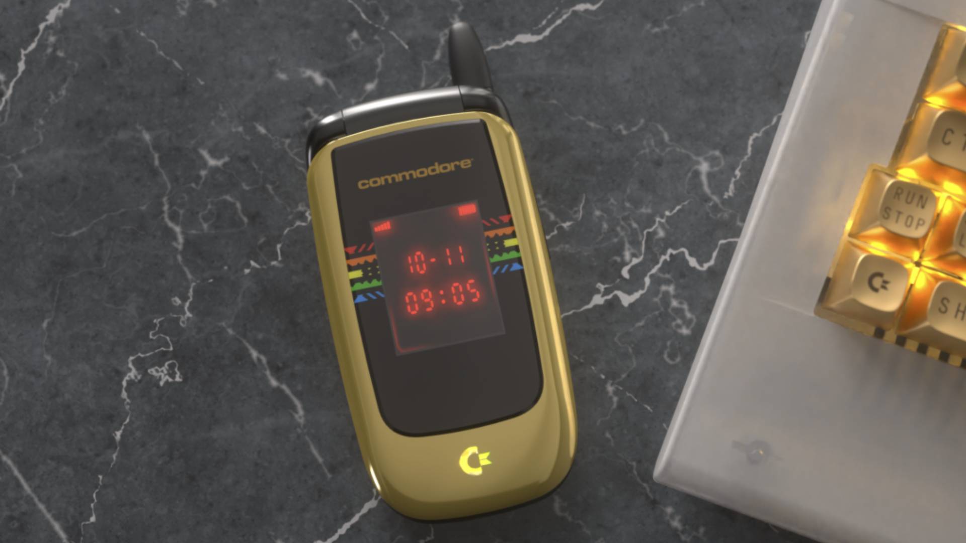 Commodore Callback 8020 flip-phone in gold sitting on marble surface with clamshell closed.