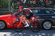 Geraint Thomas stops by his Ineos Grenadier team car after being involved in a crash