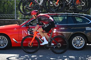 Geraint Thomas stops by his Ineos Grenadier team car after being involved in a crash