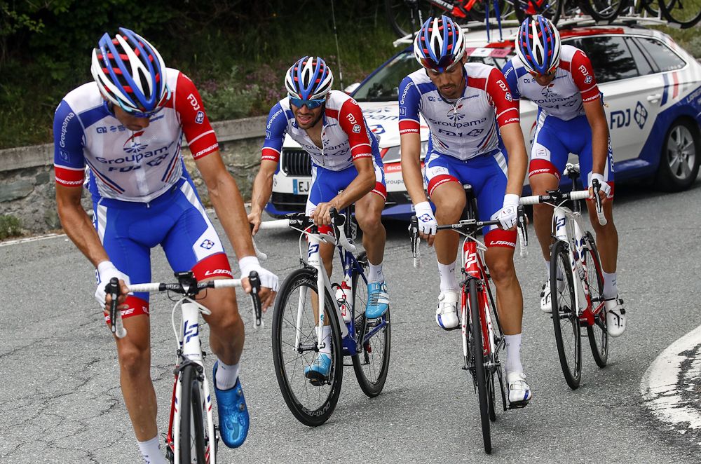 Thibaut Pinot's teammates wait as he struggles during stage 20 at the Giro d'Italia