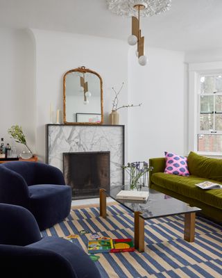 A living room with blue armchairs, and green couch