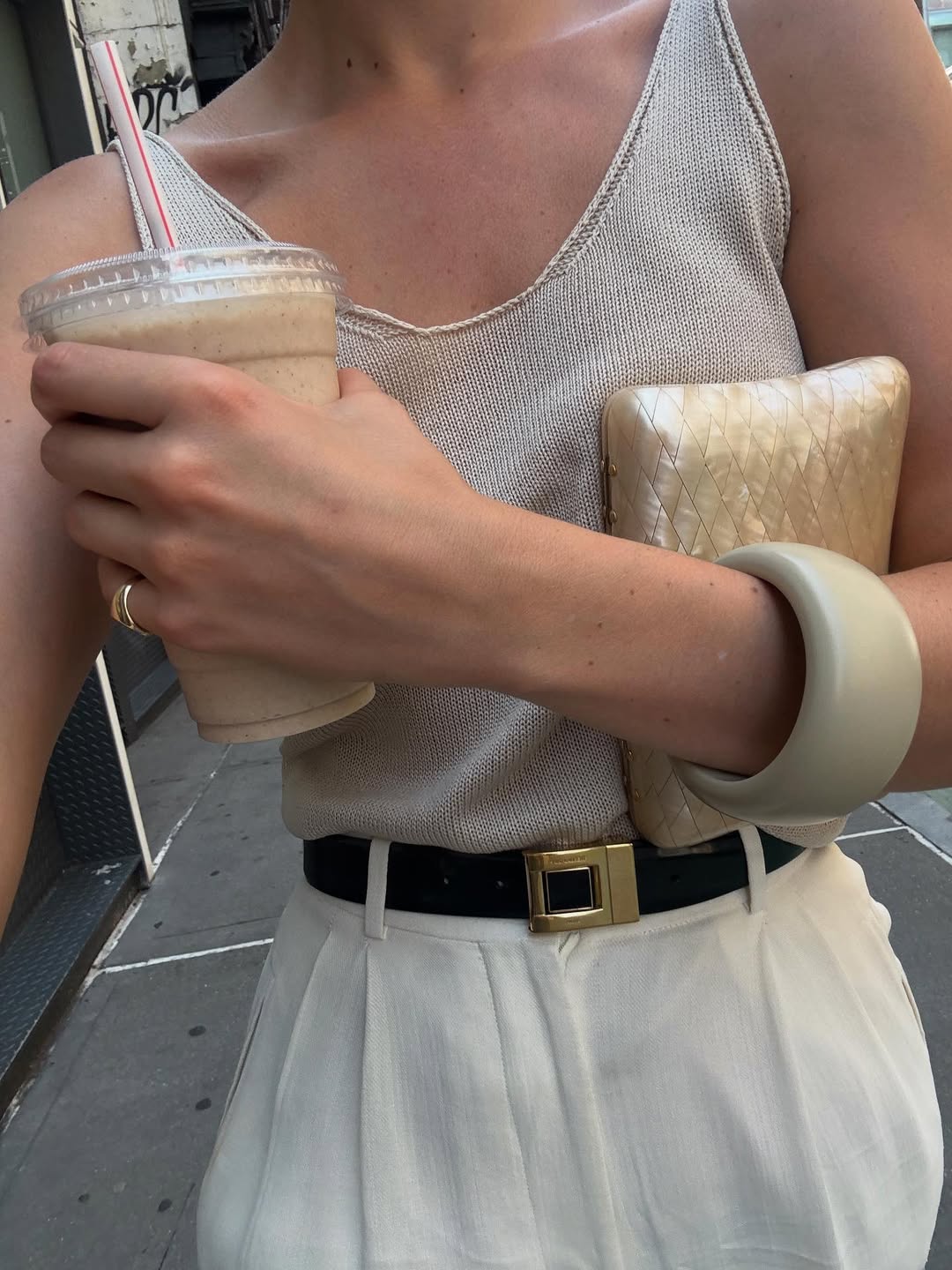 Christie holding a pearlescent clutch