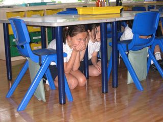 Children participating in an earthquake drill on April 23, 2009, at the British School in Tokyo.