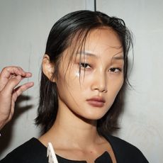 A model with shiny cheekbone highlighter.