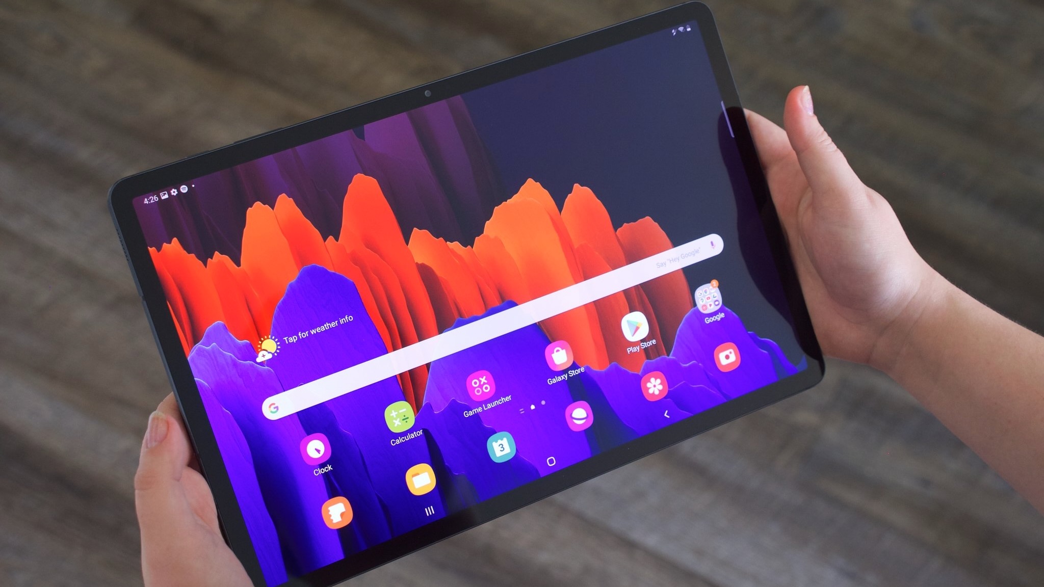 Holding the Samsung Galaxy Tab S7 Plus in a two-handed grip