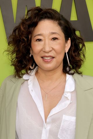 Sandra Oh smiling with brunette curly hair