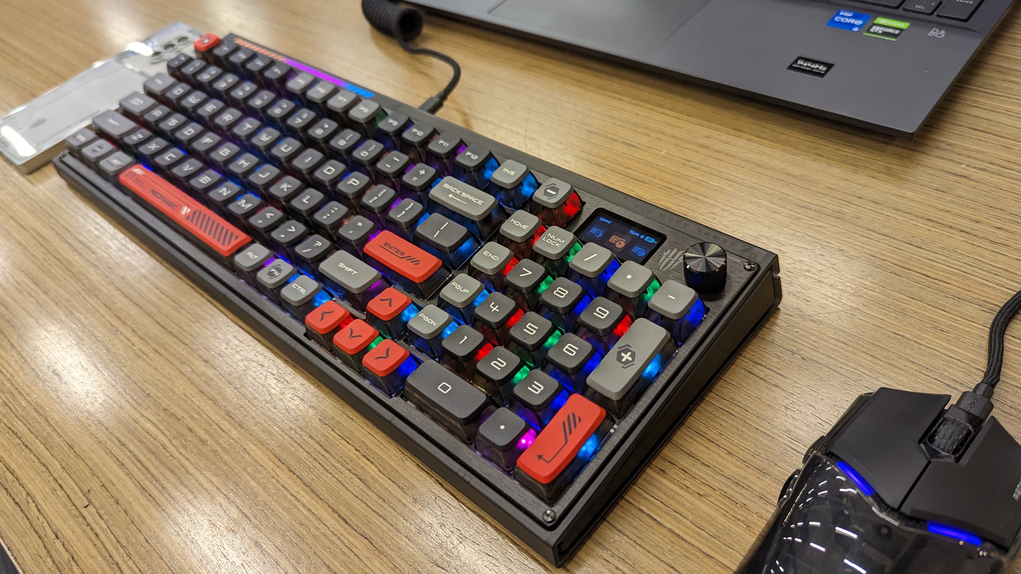 RedMagic Mouse and Mechanical Keyboard on a wooden desk.